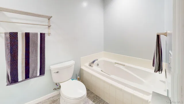 a bathroom with a toilet and a shower curtain