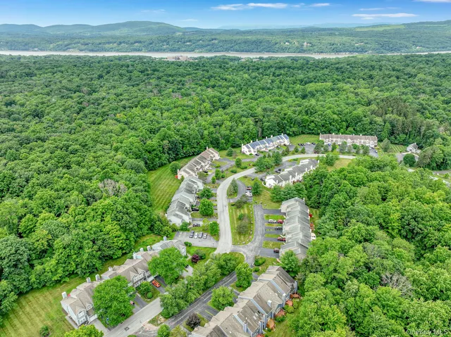 a front view of a house with a garden and plants