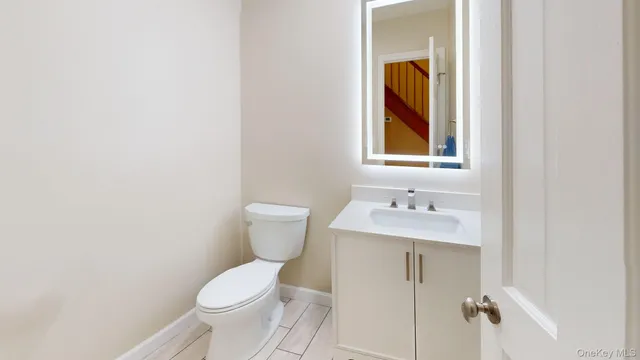 a bathroom with a toilet a sink and mirror