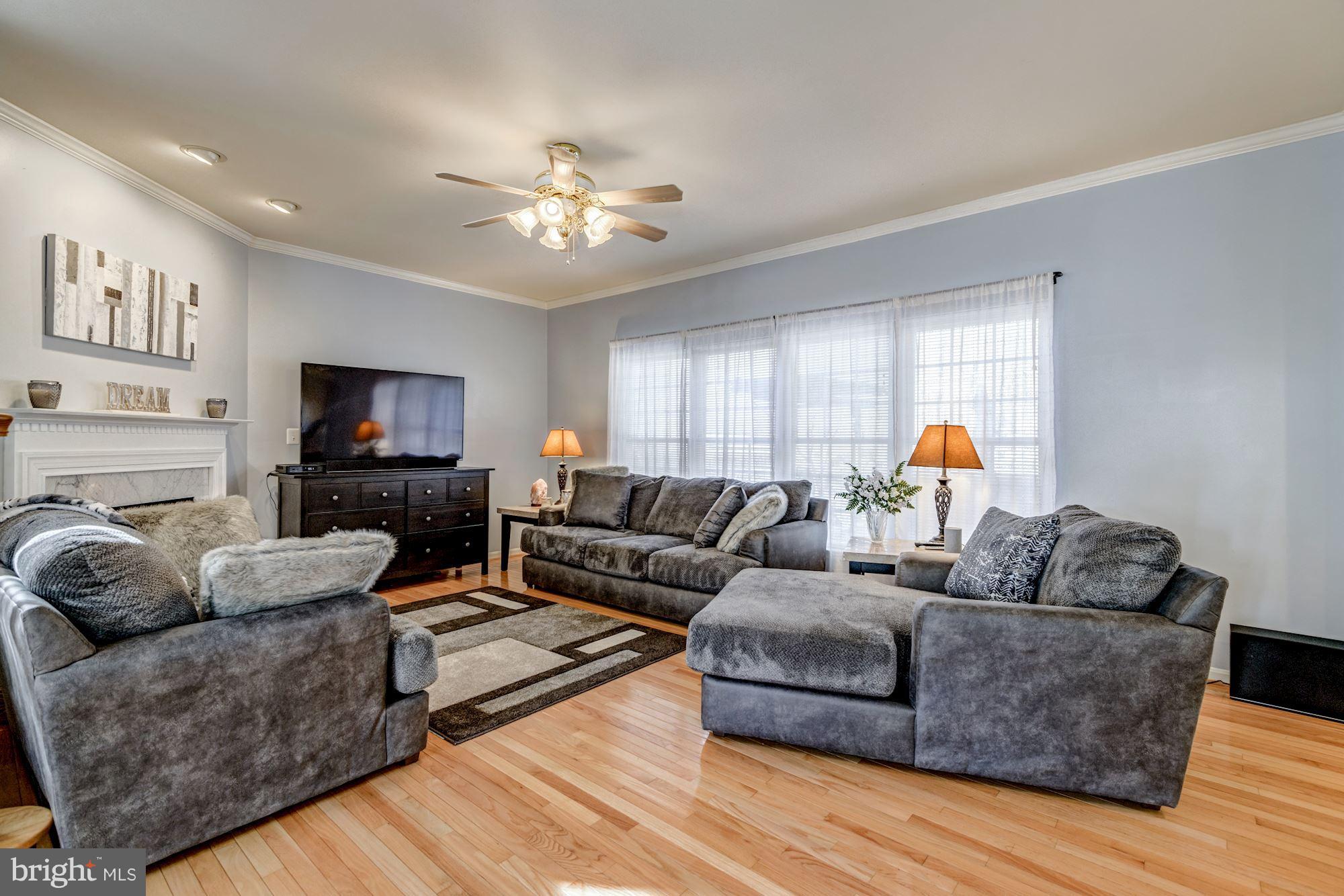 6092 Deer Ridge Trail Springfield, VA 22150 - Photo 11 of 30 a living room with furniture and a flat screen tv