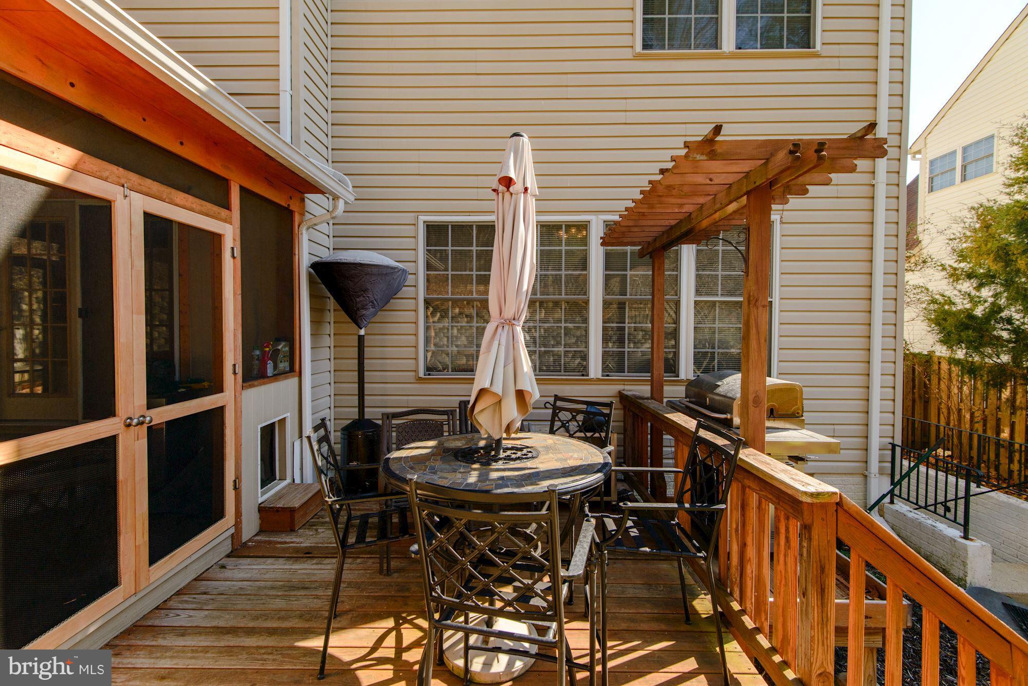 6092 Deer Ridge Trail Springfield, VA 22150 - Photo 14 of 30 a view of a patio with table and chairs and wooden floor