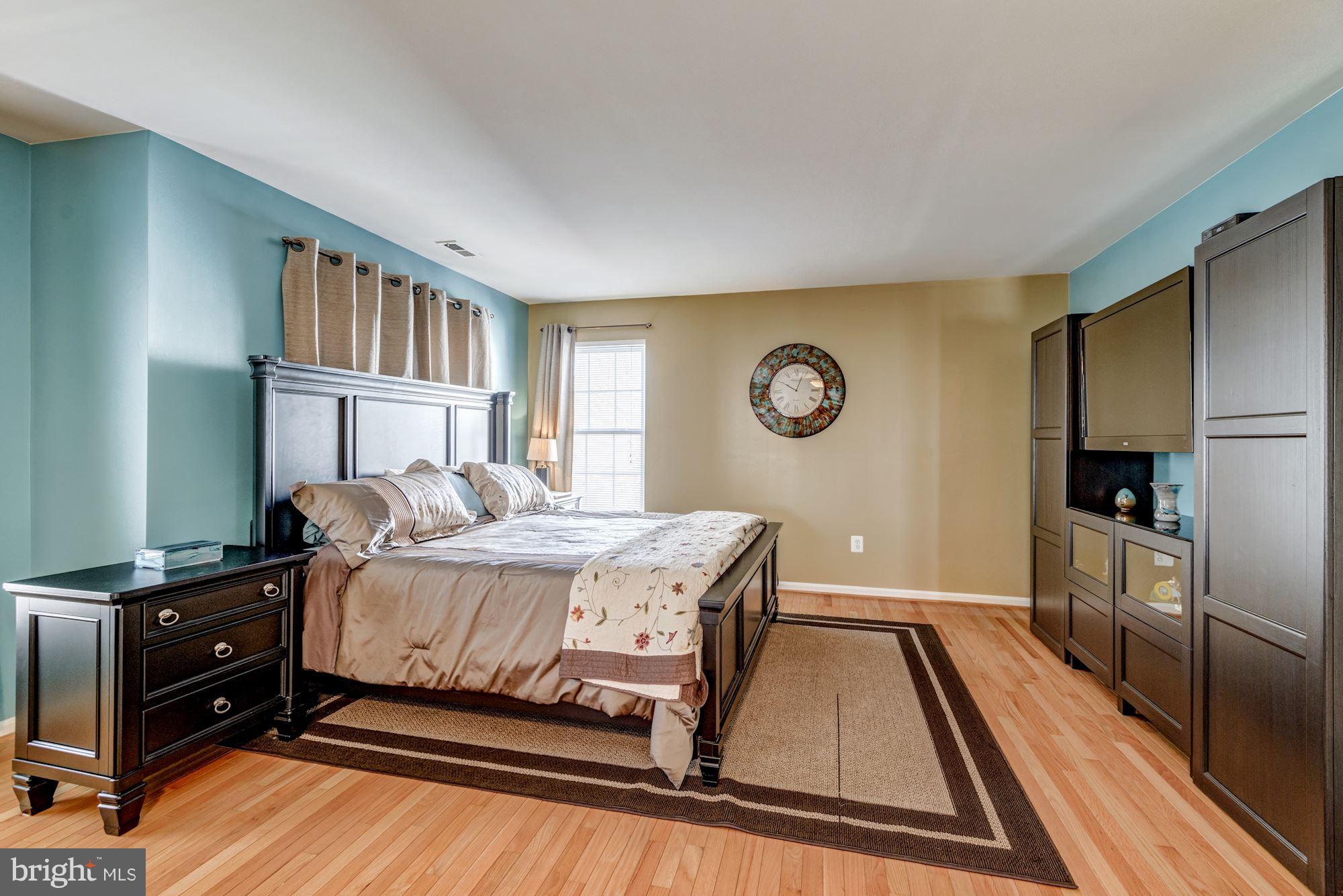 6092 Deer Ridge Trail Springfield, VA 22150 - Photo 16 of 30 a bedroom with a bed and a flat tv screen on the dresser