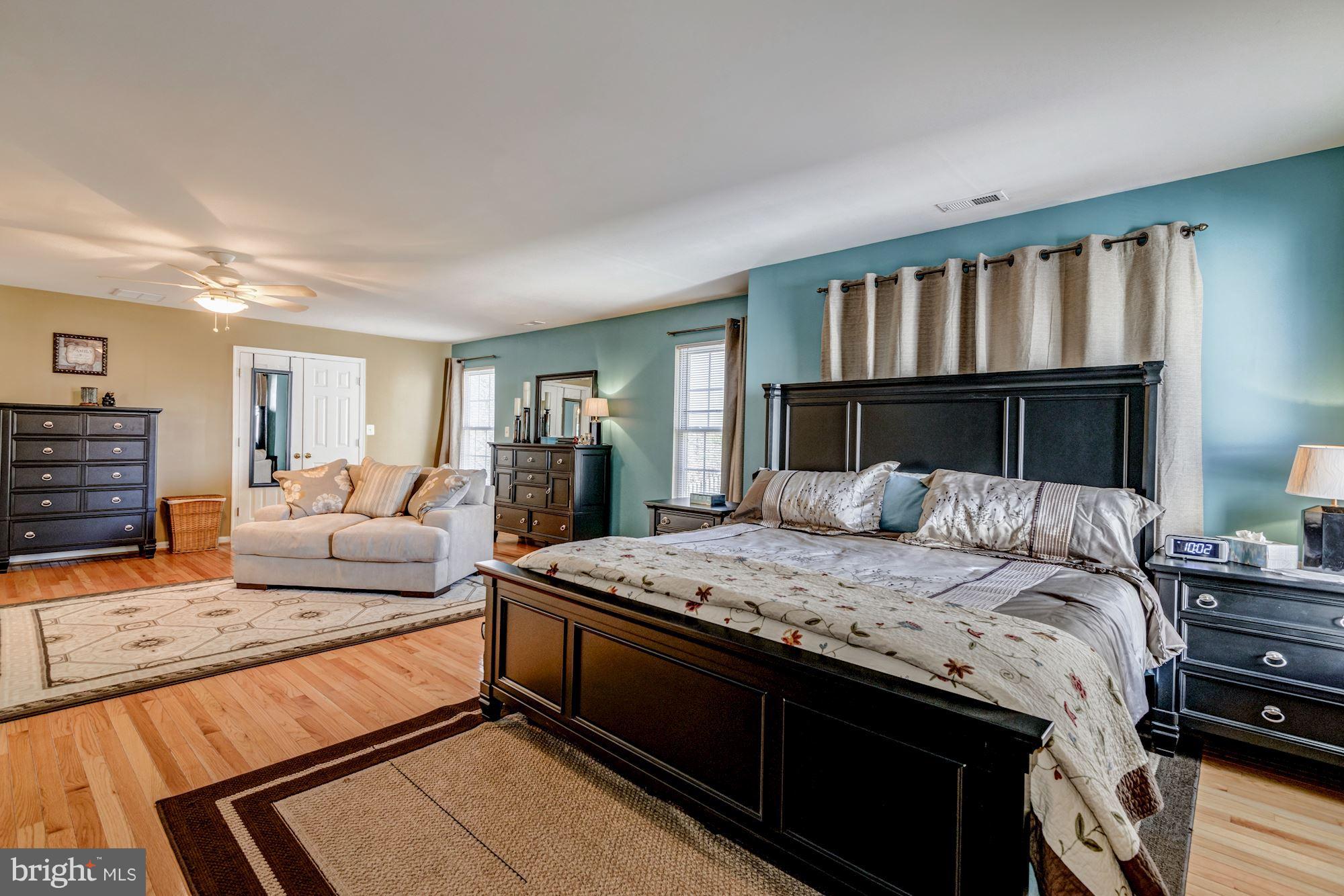 6092 Deer Ridge Trail Springfield, VA 22150 - Photo 17 of 30 a bedroom with a large bed and a couch