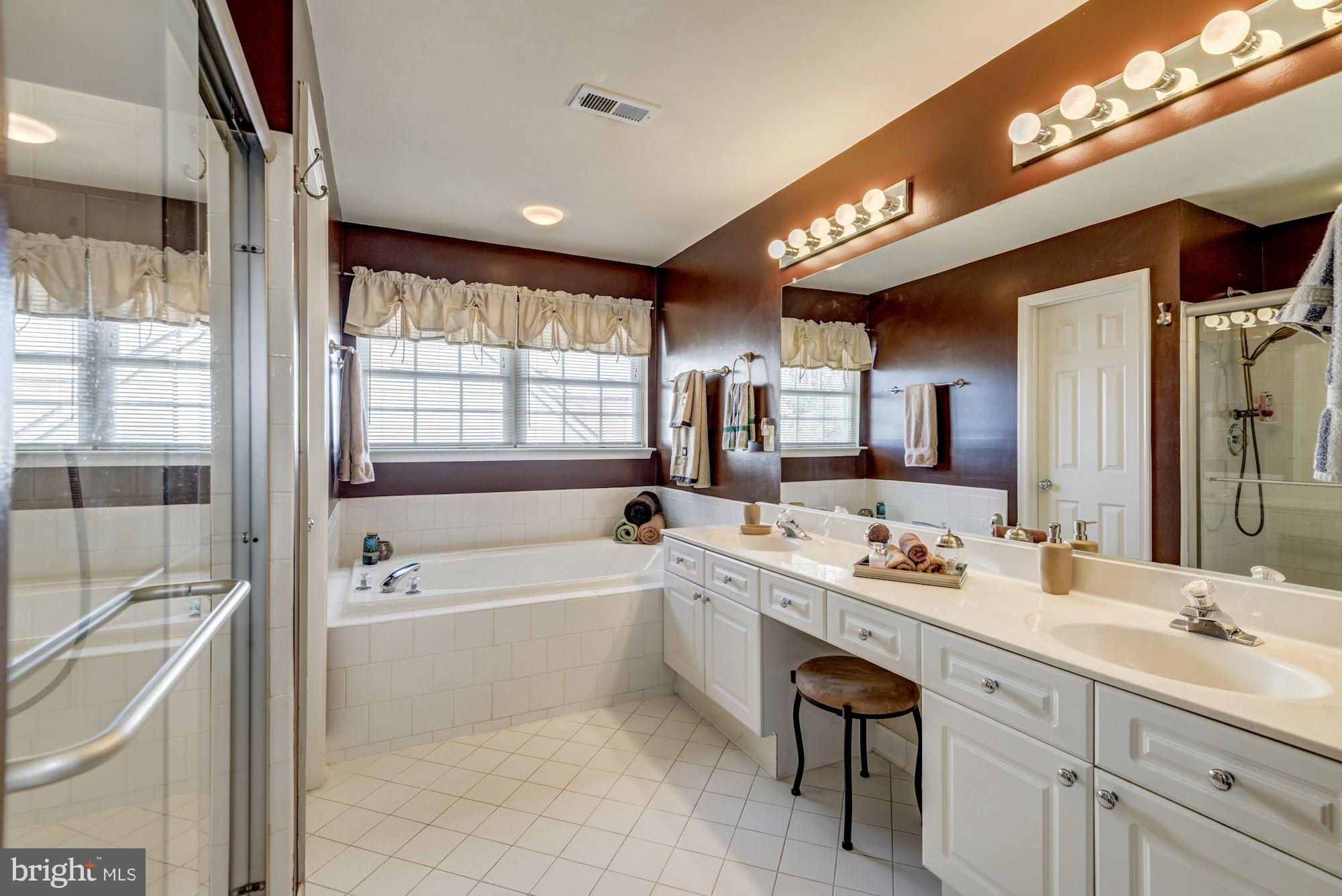 6092 Deer Ridge Trail Springfield, VA 22150 - Photo 18 of 30 a bathroom with a tub sink double vanity granite and a large mirror