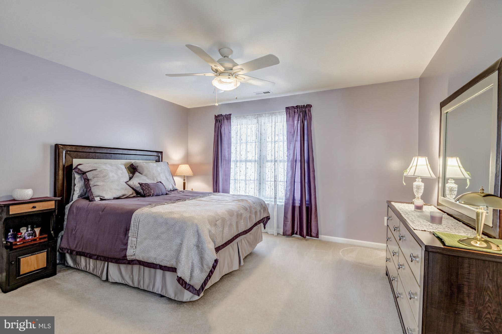 6092 Deer Ridge Trail Springfield, VA 22150 - Photo 21 of 30 a bedroom with a bed and a chandelier