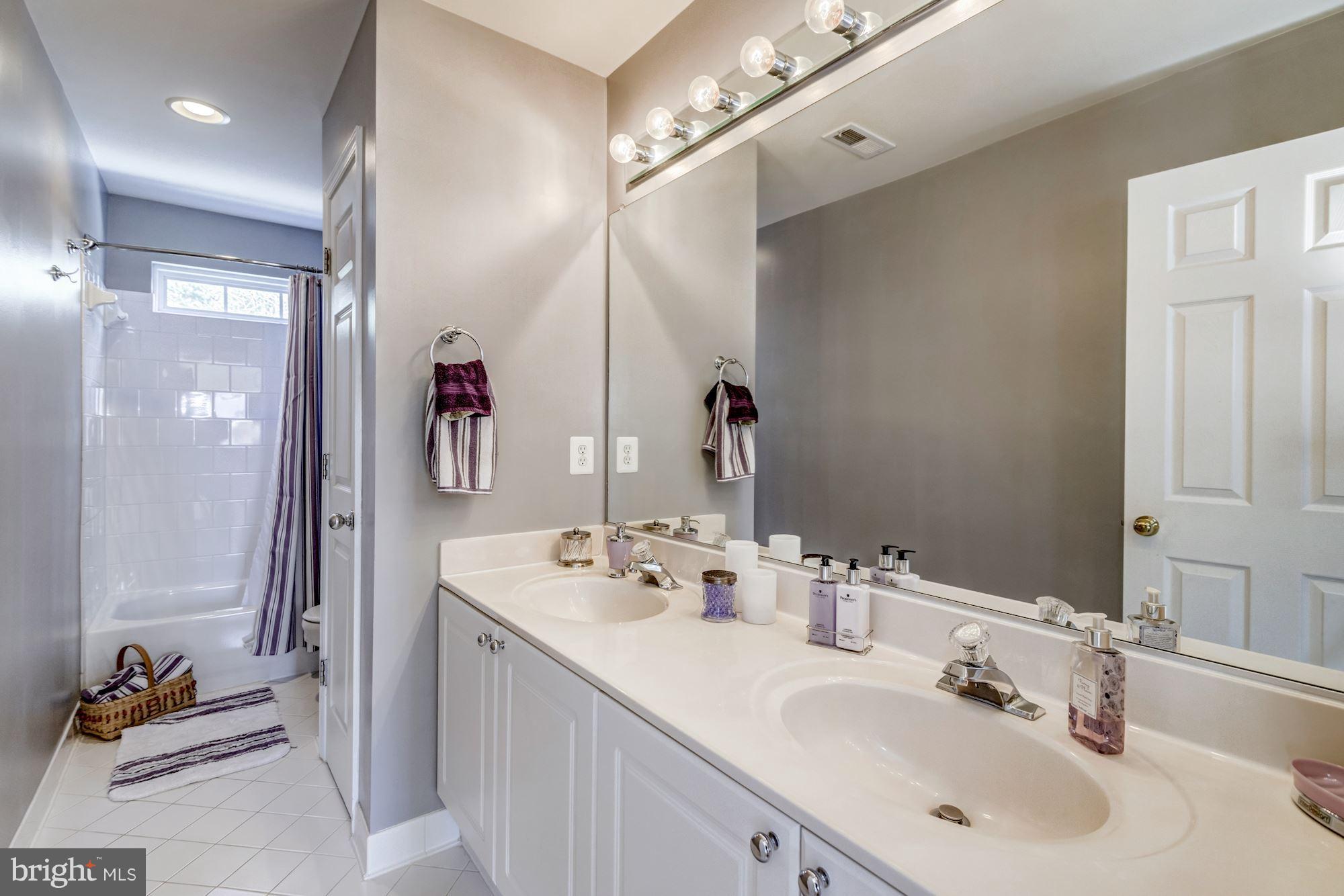 6092 Deer Ridge Trail Springfield, VA 22150 - Photo 22 of 30 a bathroom with a double vanity sink and a mirror