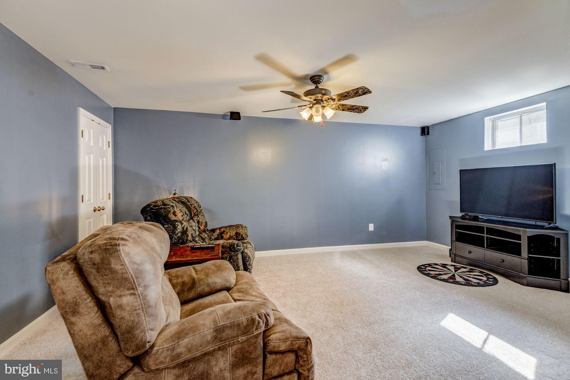 6092 Deer Ridge Trail Springfield, VA 22150 - Photo 27 of 30 a living room with furniture and a flat screen tv