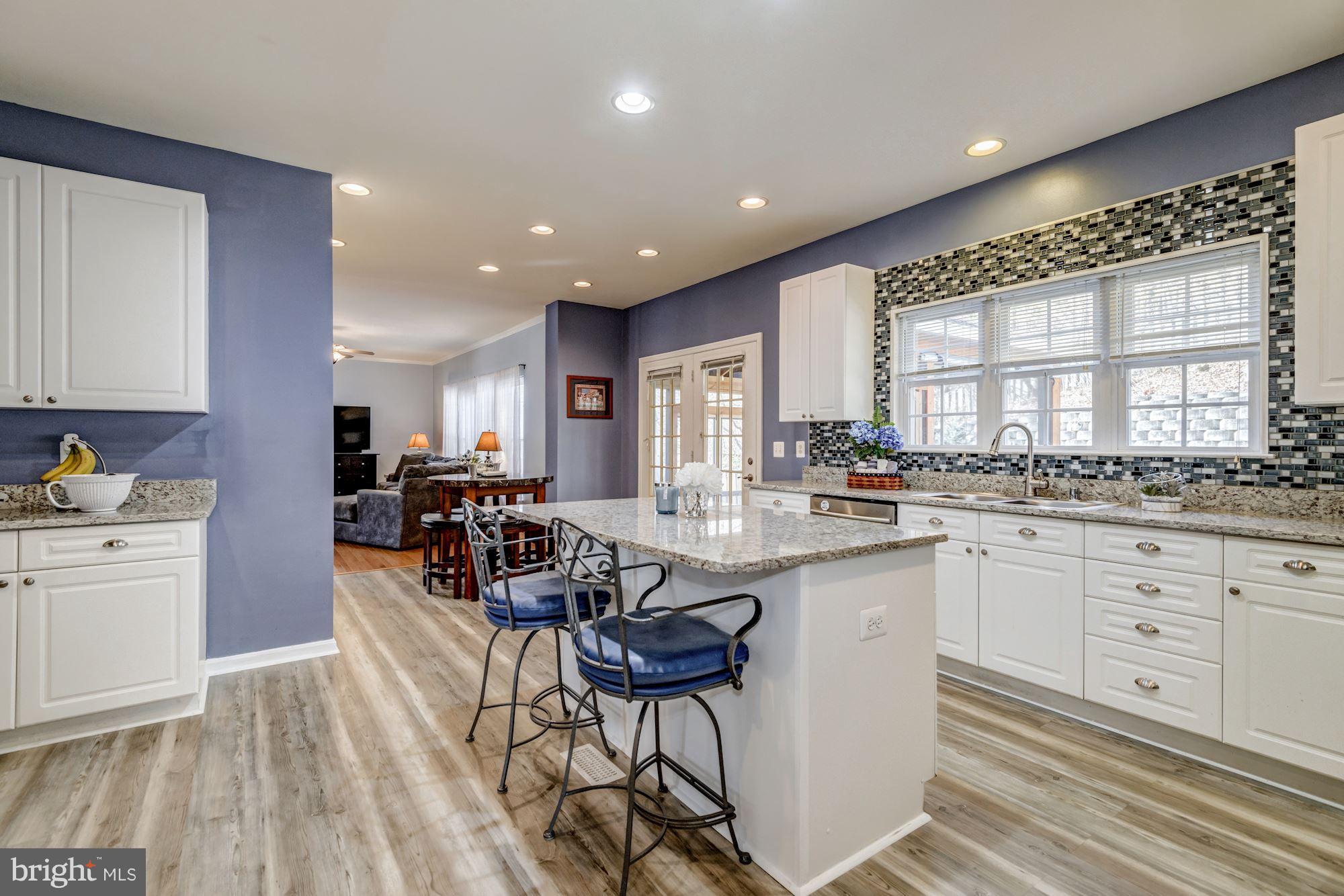 6092 Deer Ridge Trail Springfield, VA 22150 - Photo 6 of 30 a kitchen with sink cabinets and dining table chair