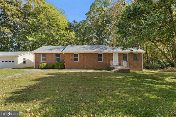 a front view of house with yard and trees