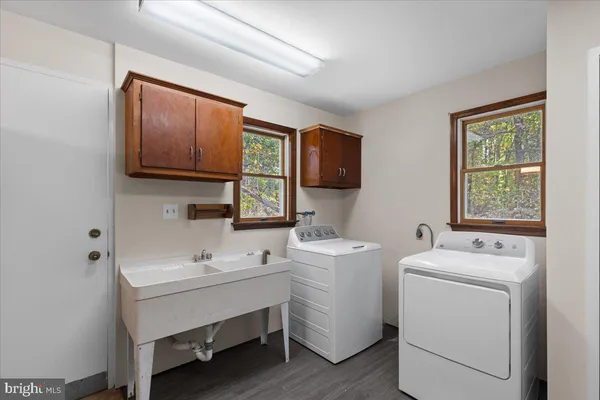 a utility room with dryer washer and a window