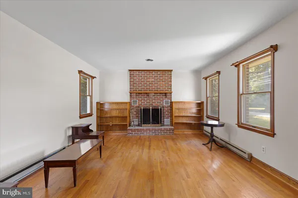 a living room with furniture fireplace and window