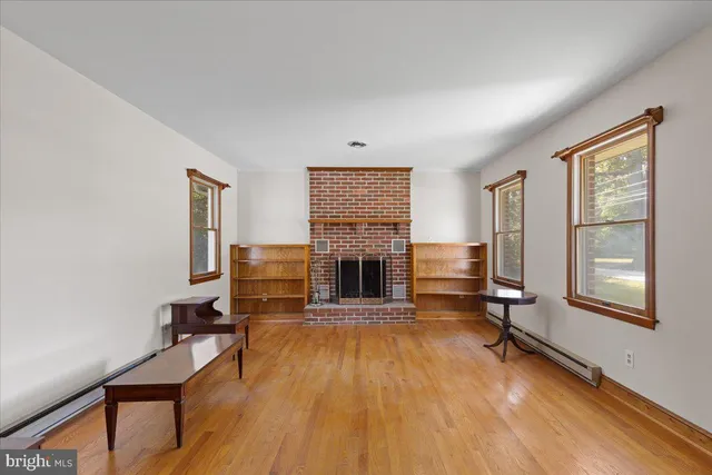 a living room with furniture fireplace and window