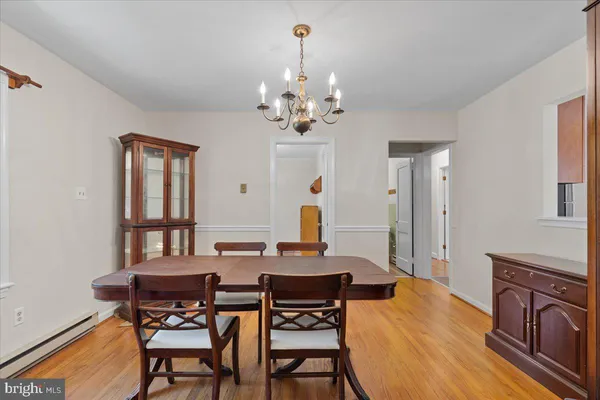 a view of a dining room with furniture and a chandelier