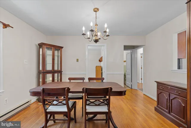 a view of a dining room with furniture and a chandelier