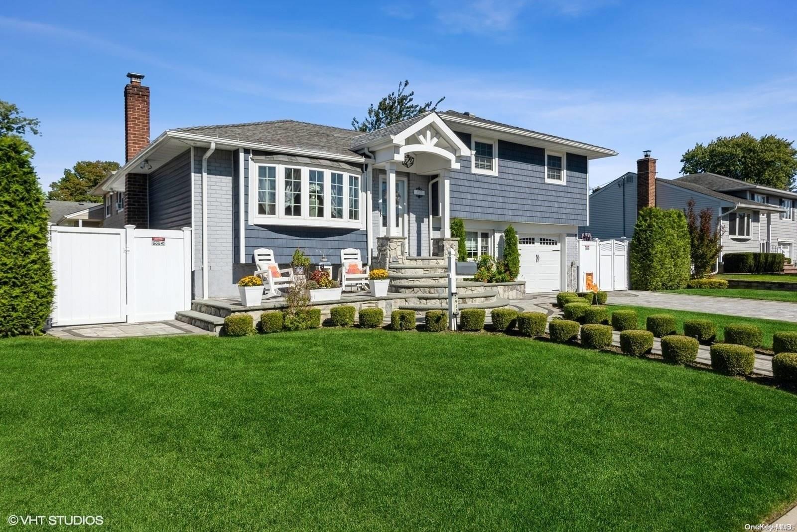 3919 Ralph Street South Seaford, NY 11783 - Photo 1 of 1 a front view of a house with a garden