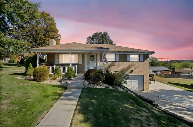 a front view of a house with a yard table and chairs