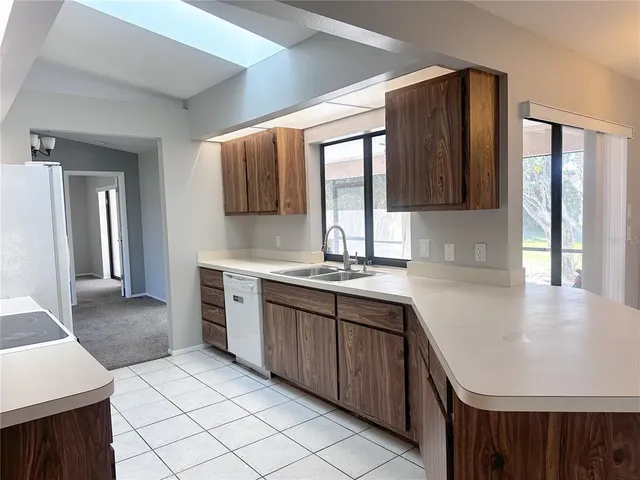 a kitchen with a sink stove and refrigerator