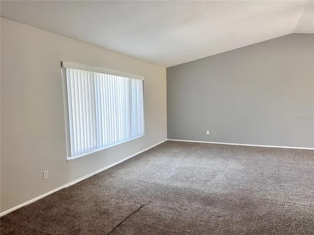 a view of an empty room and a window