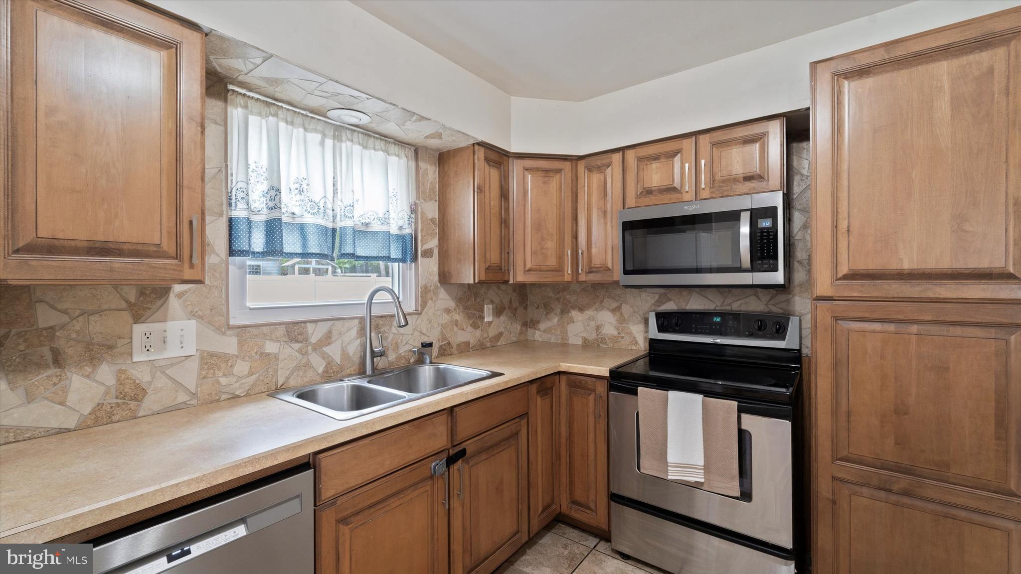 37 Brookview Drive Atco, NJ 08004 - Photo 9 of 27 a kitchen with appliances a sink and cabinets