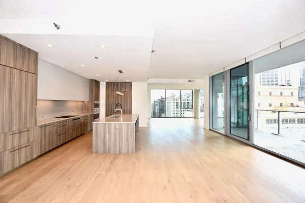 a kitchen with stainless steel appliances a sink stove and cabinets