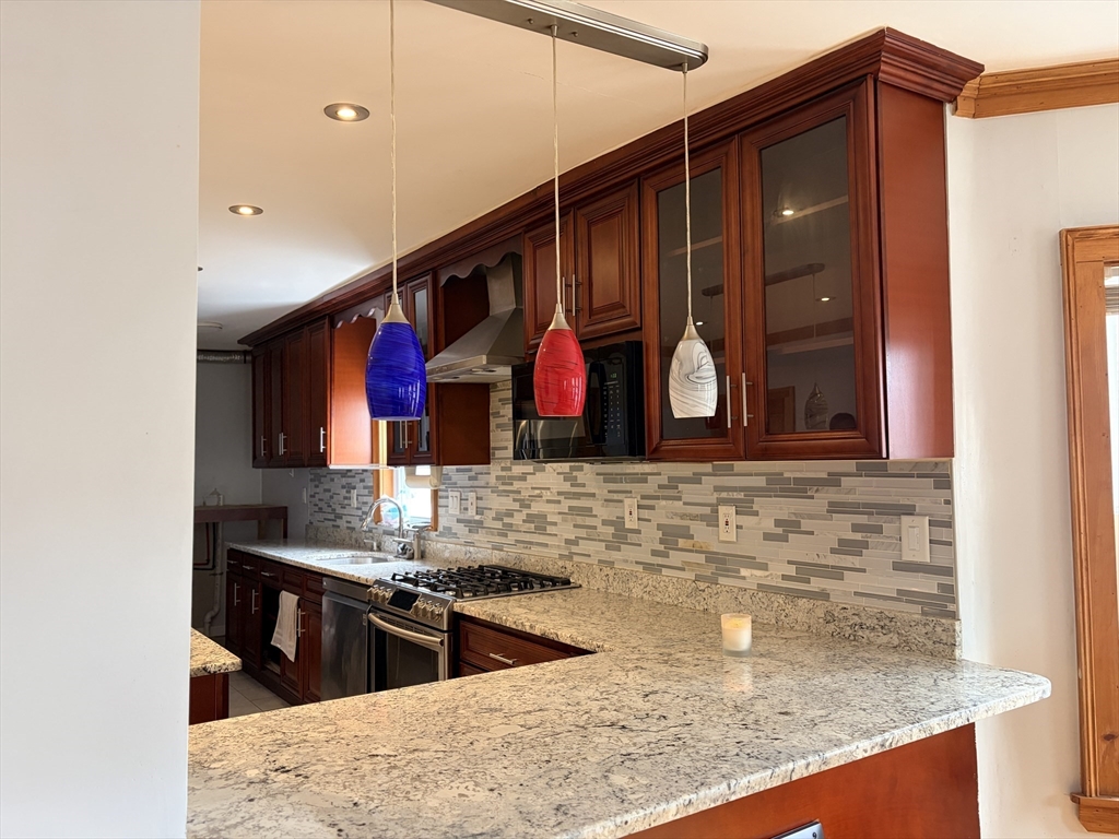 91 Ward Street, Unit 1 Worcester, MA 01610 - Photo 2 of 12 a kitchen with stainless steel appliances granite countertop a sink and a stove