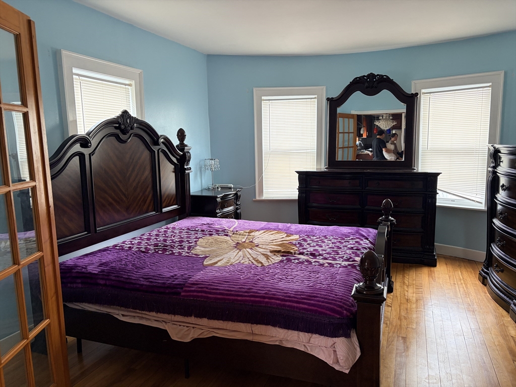 91 Ward Street, Unit 1 Worcester, MA 01610 - Photo 5 of 12 a bedroom with a bed and a dresser