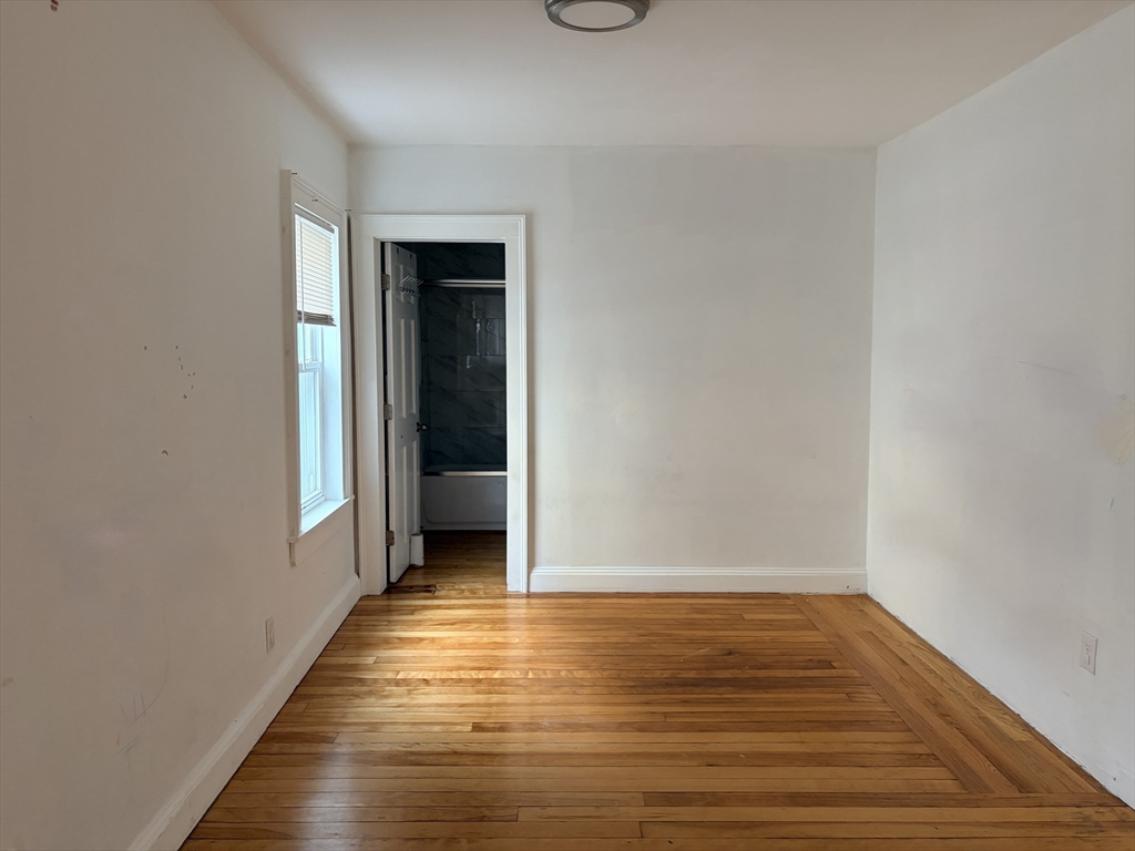 91 Ward Street, Unit 1 Worcester, MA 01610 - Photo 6 of 12 a view of a hallway with wooden floor