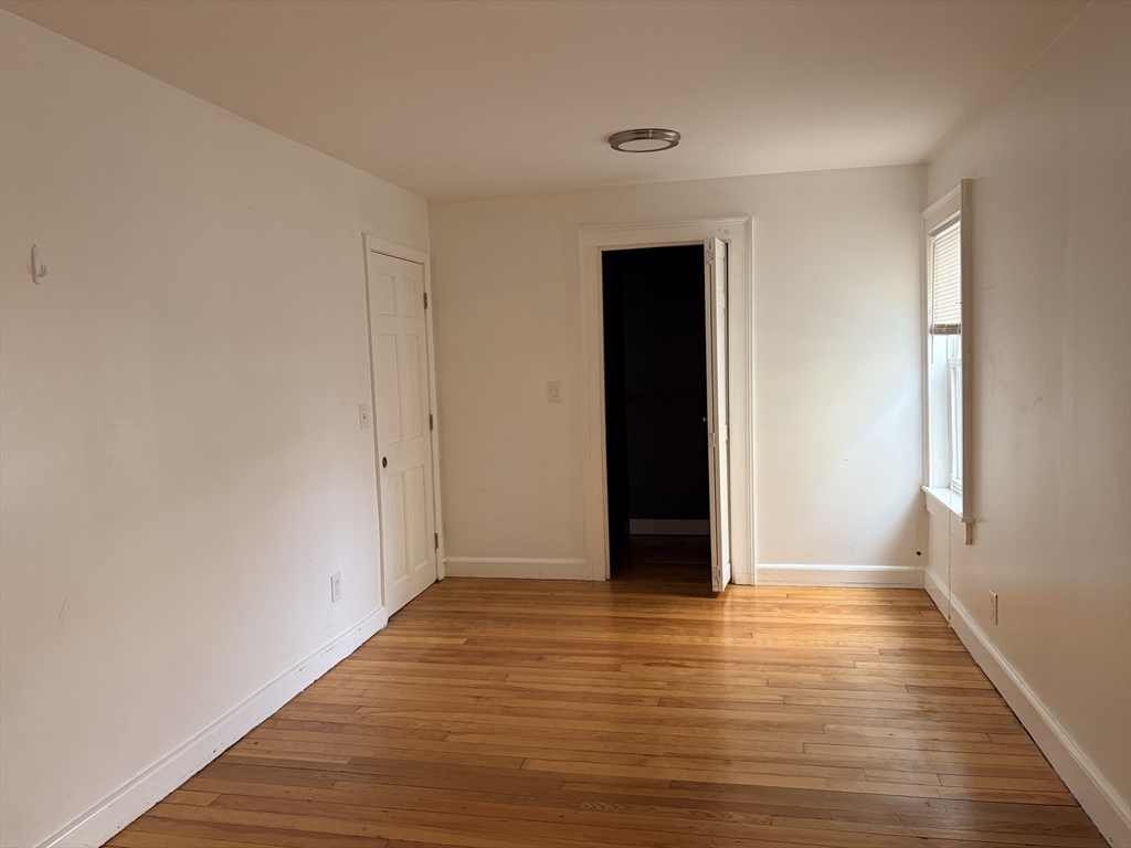 91 Ward Street, Unit 1 Worcester, MA 01610 - Photo 7 of 12 a view of an empty room with wooden floor