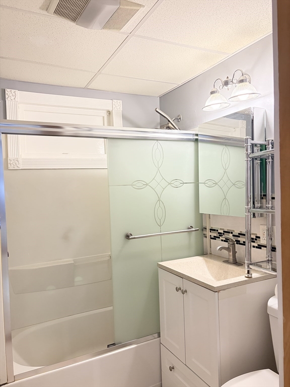 91 Ward Street, Unit 1 Worcester, MA 01610 - Photo 8 of 12 a bathroom with a sink mirror vanity and toilet