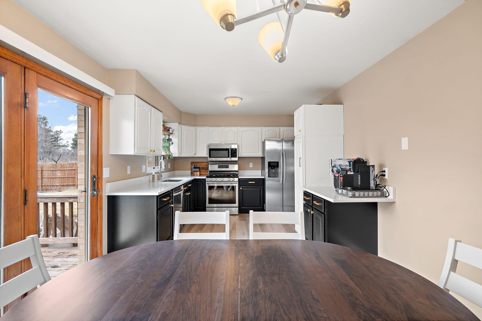 2164 Terrace Drive Highland, IN 46322 - Photo 13 of 34 a kitchen with stainless steel appliances kitchen island granite countertop a refrigerator a stove top oven a sink dishwasher and white cabinets next to a window
