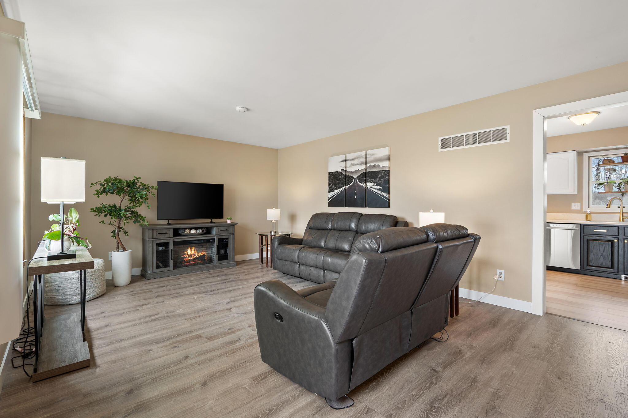 2164 Terrace Drive Highland, IN 46322 - Photo 5 of 34 a living room with furniture a flat screen tv and a dining table with wooden floor
