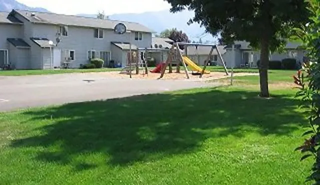 a view of outdoor space with playground and green space
