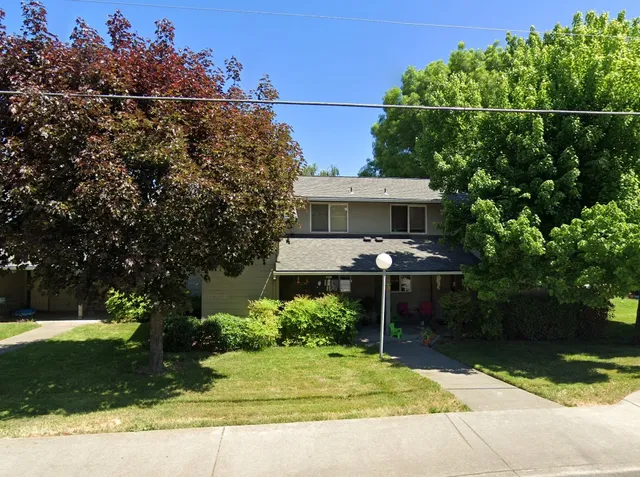 a view of a patio with table and chairs and potted plants