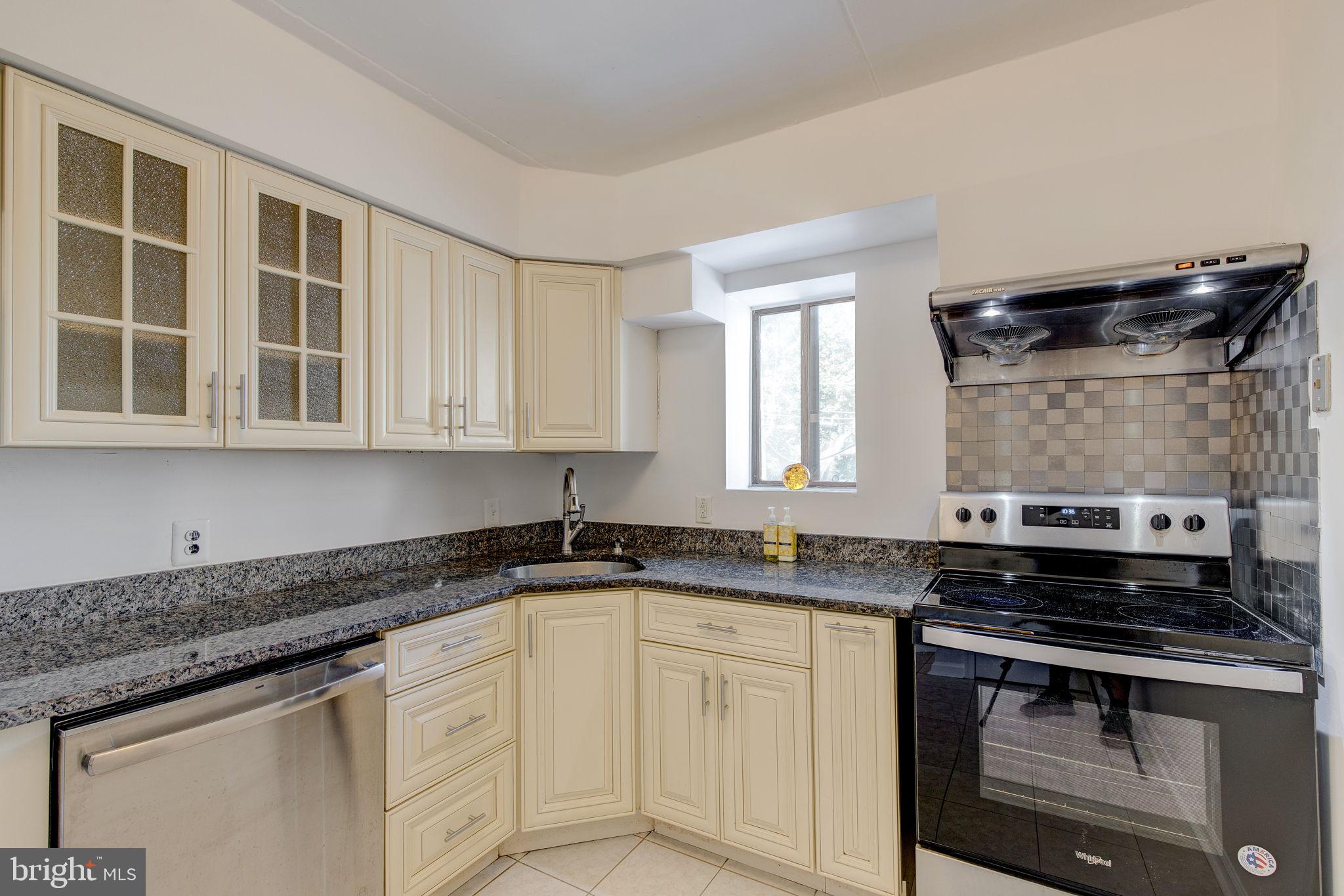 100 Rutgers Avenue, Unit 8 Swarthmore, PA 19081 - Photo 17 of 29 a kitchen with stainless steel appliances granite countertop a sink stove and cabinets