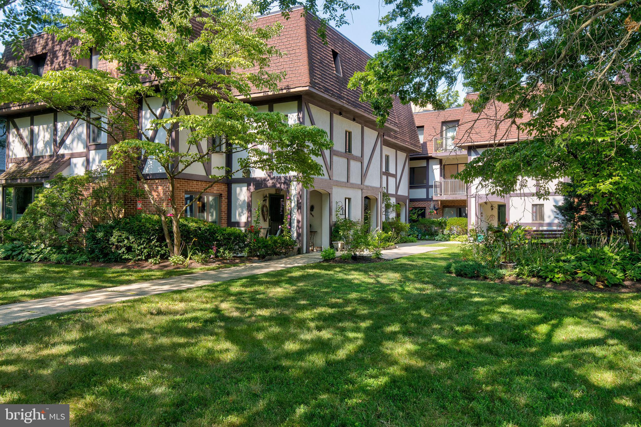 100 Rutgers Avenue, Unit 8 Swarthmore, PA 19081 - Photo 3 of 29 a view of a big yard with plants and large trees