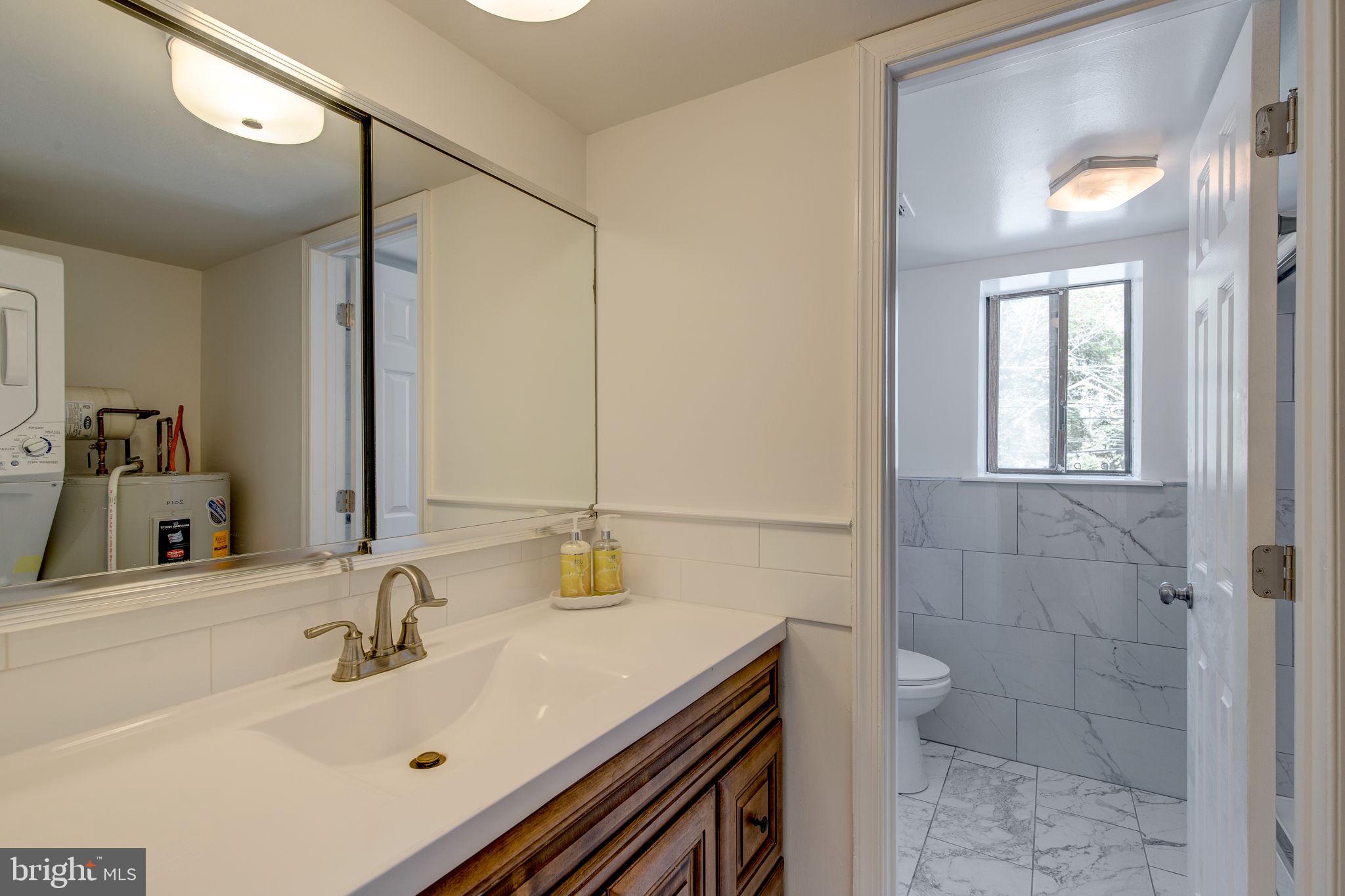 100 Rutgers Avenue, Unit 8 Swarthmore, PA 19081 - Photo 23 of 29 a bathroom with a sink and a mirror