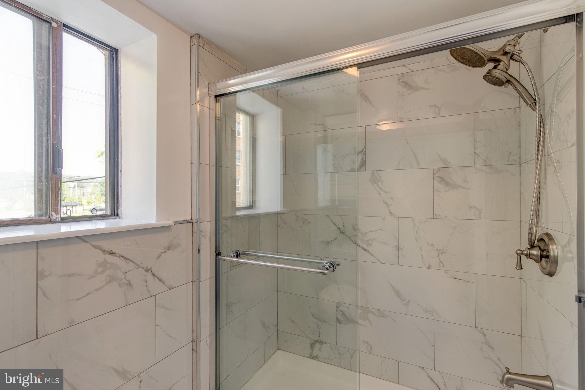 100 Rutgers Avenue, Unit 8 Swarthmore, PA 19081 - Photo 24 of 29 a bathroom with a shower and a glass door shower