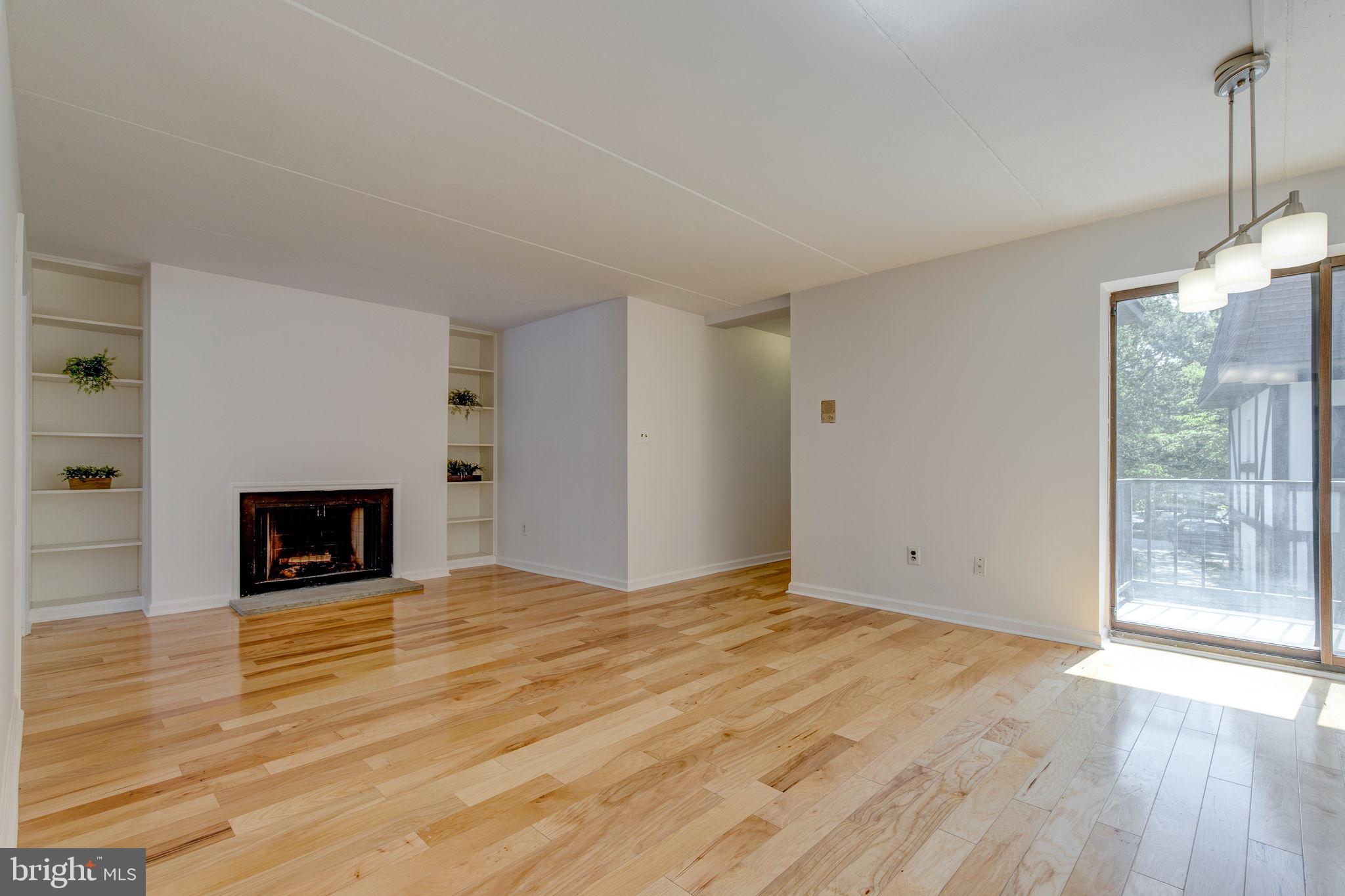 100 Rutgers Avenue, Unit 8 Swarthmore, PA 19081 - Photo 8 of 29 a view of a livingroom with wooden floor and a fireplace