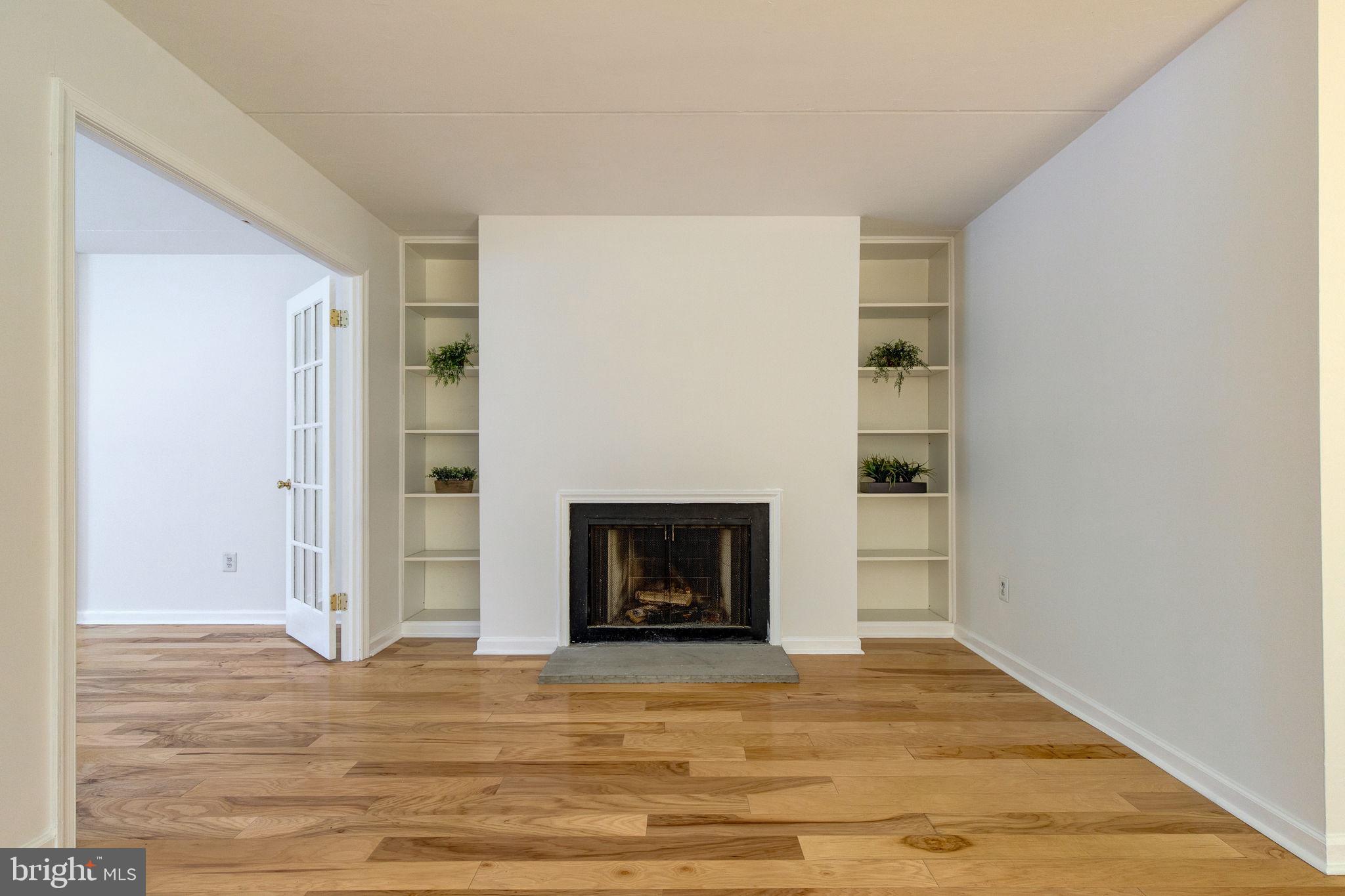 100 Rutgers Avenue, Unit 8 Swarthmore, PA 19081 - Photo 9 of 29 a view of an empty room with wooden floor and a fireplace