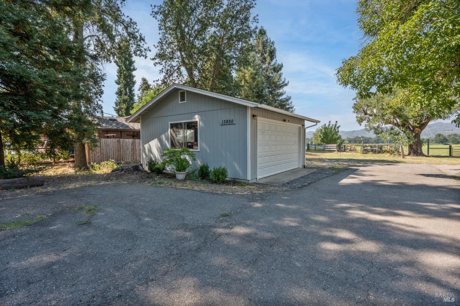 13850 Eel River Road Potter Valley, CA 95469 - Photo 23 of 26 a view of a house with a yard and large tree
