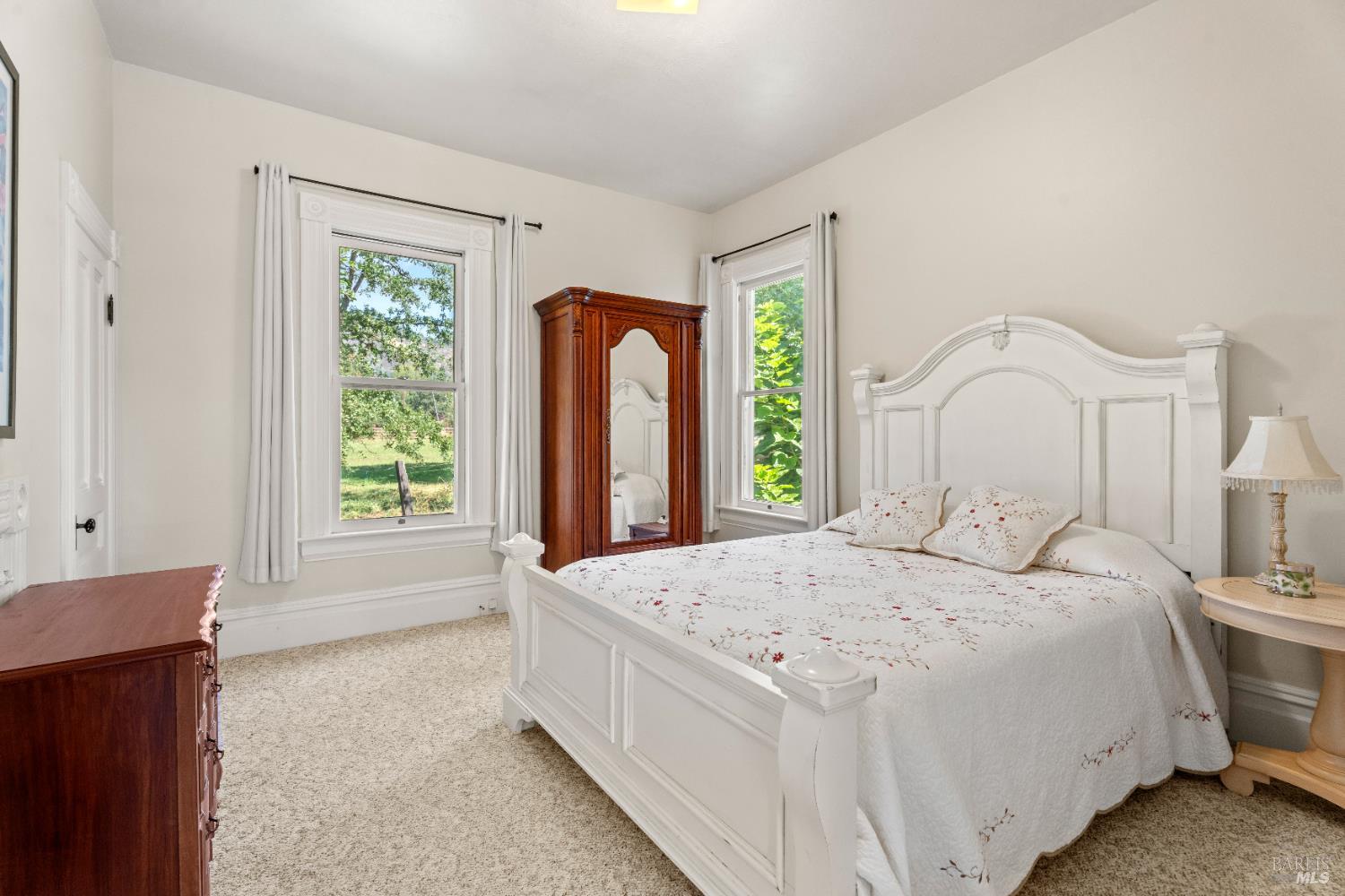 13850 Eel River Road Potter Valley, CA 95469 - Photo 5 of 26 a spacious bedroom with a bed and a large window