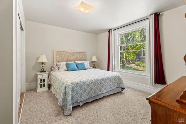 a bedroom with a bed and window