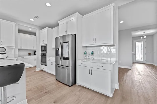 a kitchen with stainless steel appliances a refrigerator sink and cabinets