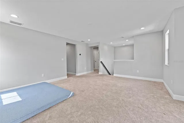 a bedroom with a large bed and a large window