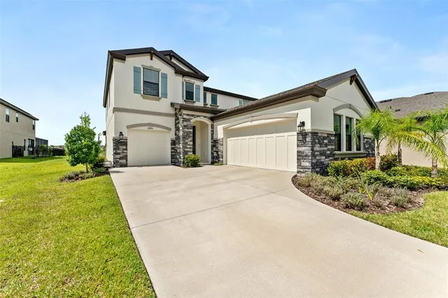 a front view of a house with a yard and garage