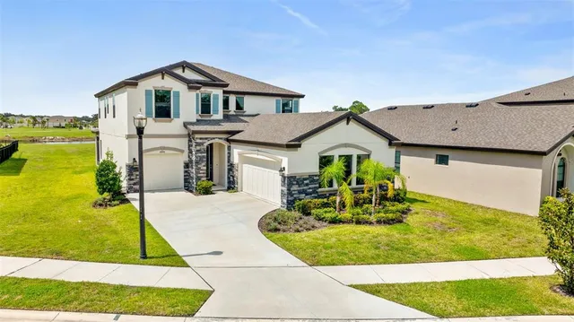an aerial view of a house with a swimming pool yard and outdoor seating