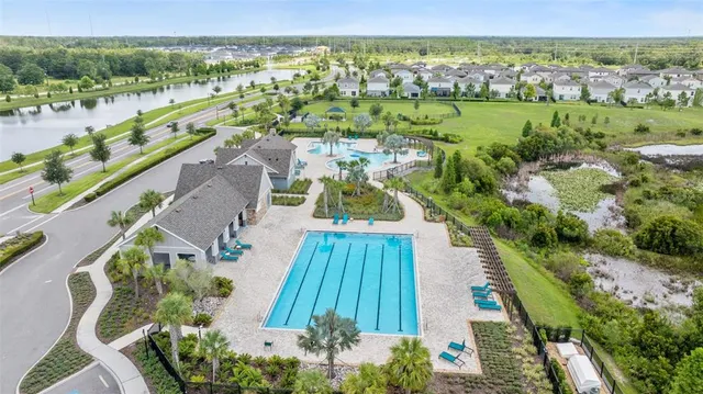 an aerial view of residential houses with outdoor space and swimming pool