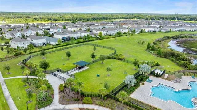 an aerial view of a house with swimming pool and outdoor space