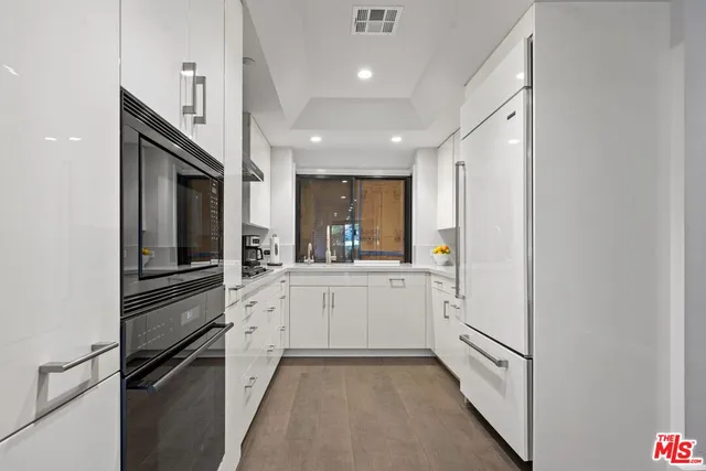 a kitchen with stainless steel appliances a refrigerator and a sink