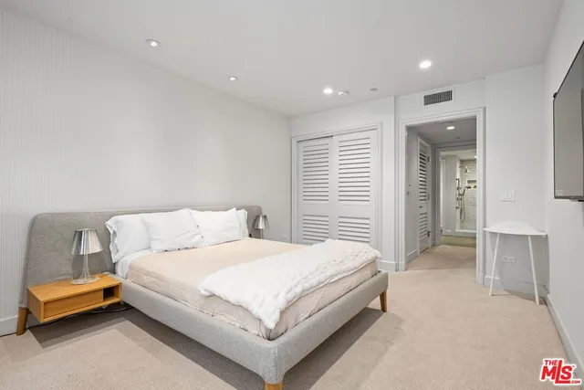 a bedroom with a bed and a couch